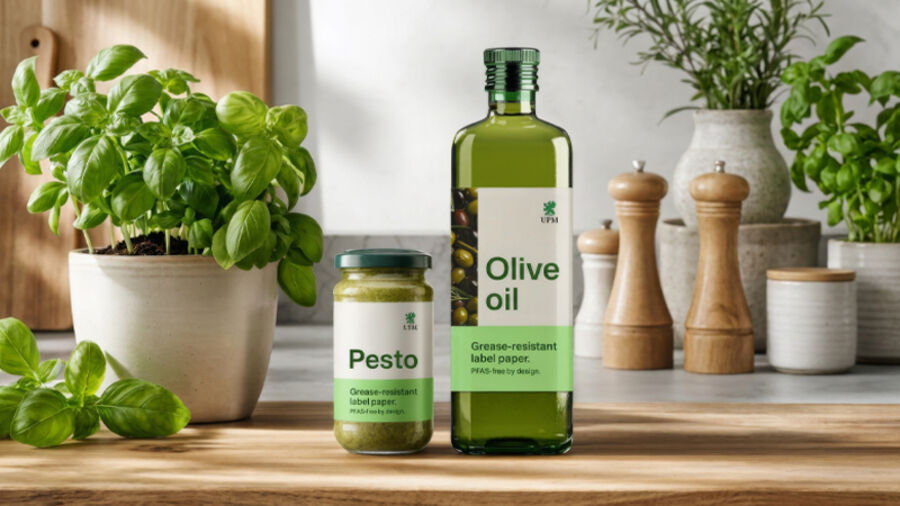 A bottle of olive oil and a jar of pesto displaying UPM's PFAS-free grease-resistant label paper.