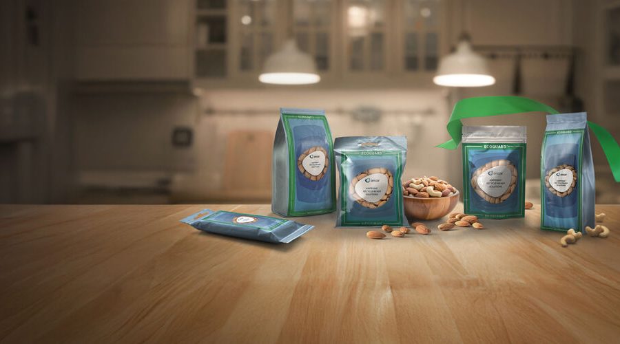 A green and blue Amcor AmPrima recycle-ready stand-up pouch filled with mixed nuts