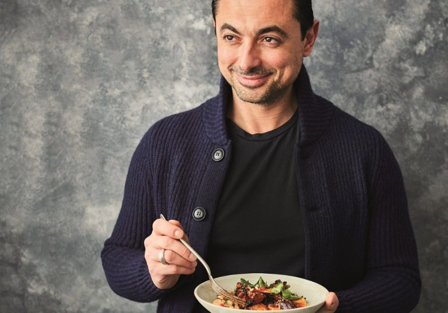 TV Chef Theo Michaels smiling and holding a recipe bowl for the Protein Packed Cans campaign. Image: Canned Food UK