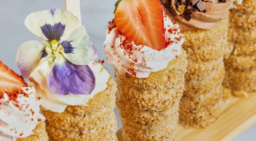 A wooden stick holding various desserts, showcasing the Trend Report on Twist it Up donut cones.