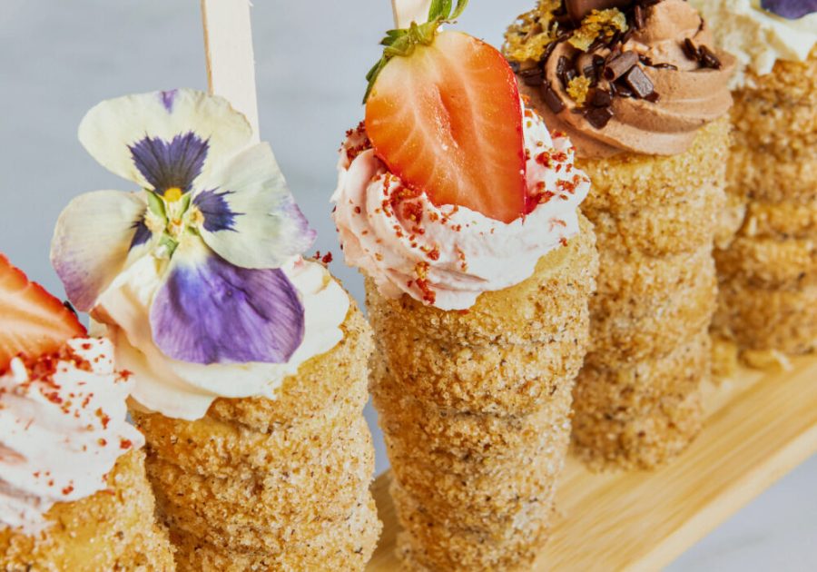 A wooden stick holding various desserts, showcasing the Trend Report on Twist it Up donut cones.