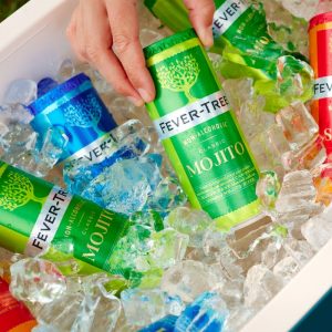 Cans of Fever-Tree beverages (Mojito, Spritz, etc.) sitting in ice in a cooler
