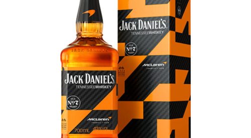 Front view of the 2026 limited edition Jack Daniel's Tennessee Whiskey 700ml bottle and its matching presentation box, featuring the custom McLaren Formula 1 Team black carbon fiber and papaya orange geometric wrap design