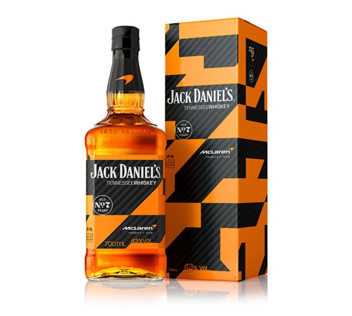 Front view of the 2026 limited edition Jack Daniel's Tennessee Whiskey 700ml bottle and its matching presentation box, featuring the custom McLaren Formula 1 Team black carbon fiber and papaya orange geometric wrap design