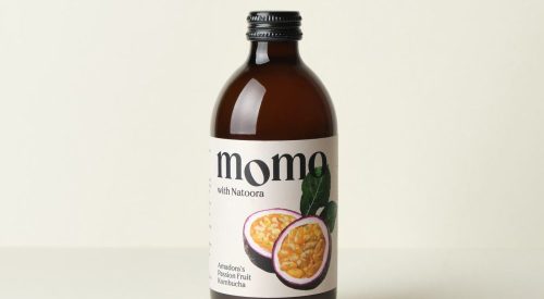 A 330ml glass bottle of MOMO Kombucha Amadora's Passion Fruit.