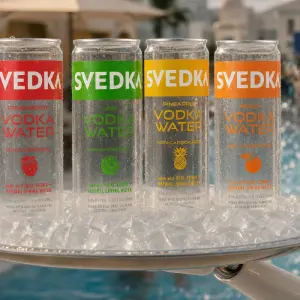 A clear, see-through 12-ounce can of Svedka Vodka Water revealing the fruit-flavoured liquid inside.